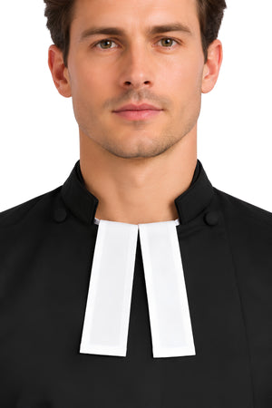 White Faithful Presence preaching bands worn at the collar of a black clergy shirt, showing the traditional tuck-in style.