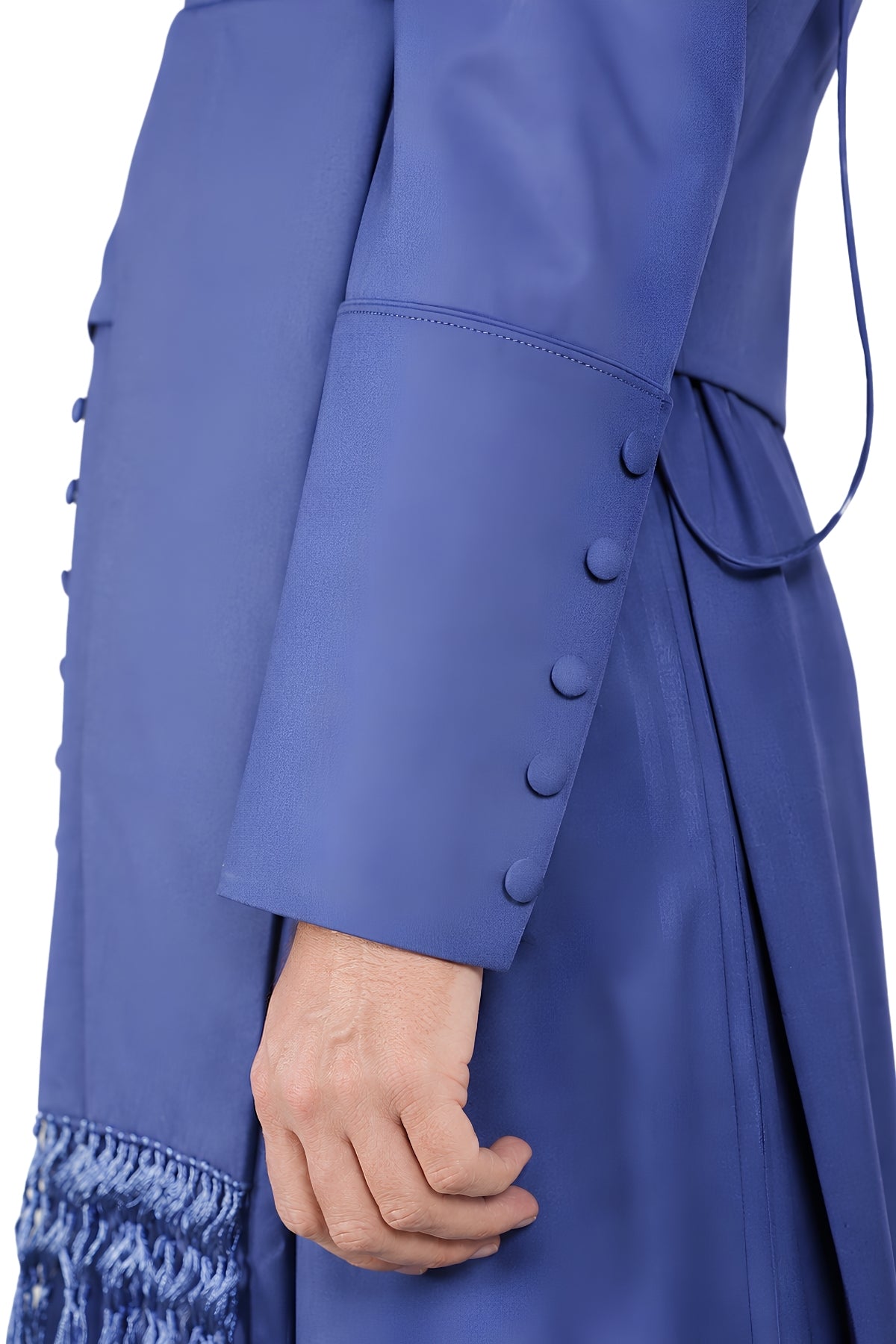 Close-up of cuff buttons and fringed cincture tassel on solid royal blue cassock for men