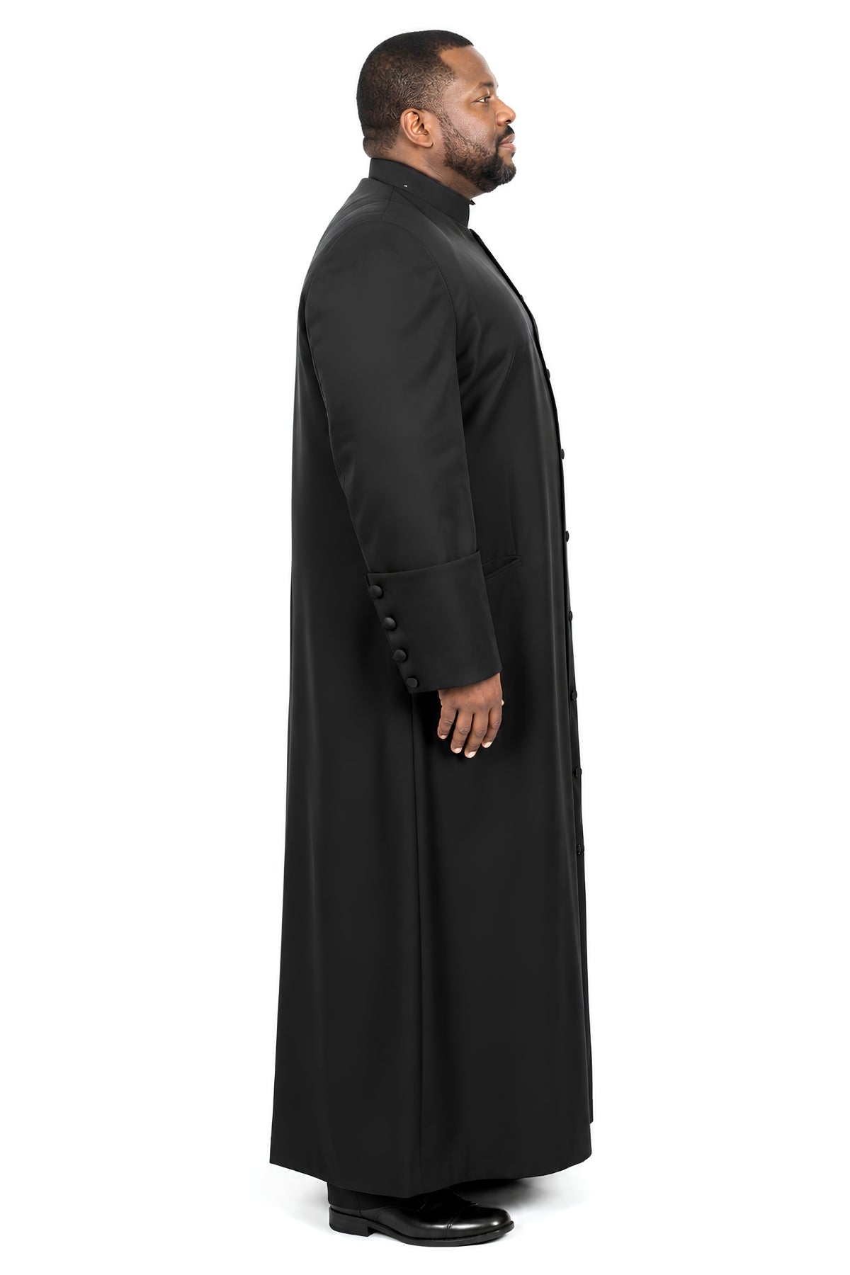 Side view of black plus-size cassock for men showing button-front closure and welt pocket detail