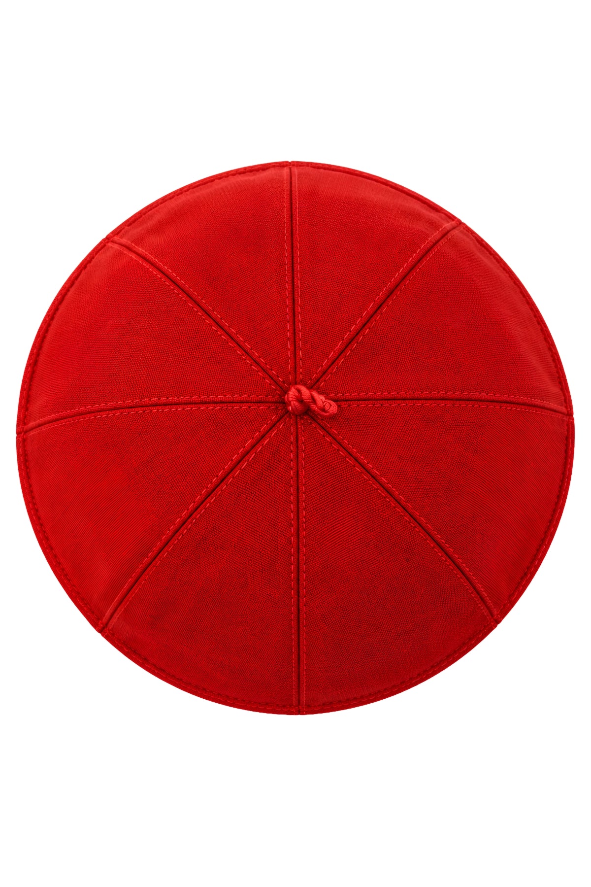 Top view of a red clergy zucchetto cap showing its eight stitched fabric panels converging at the center crown loop.
