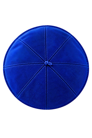 Top view of a royal blue clergy zucchetto cap showing eight stitched fabric panels meeting at the center crown.
